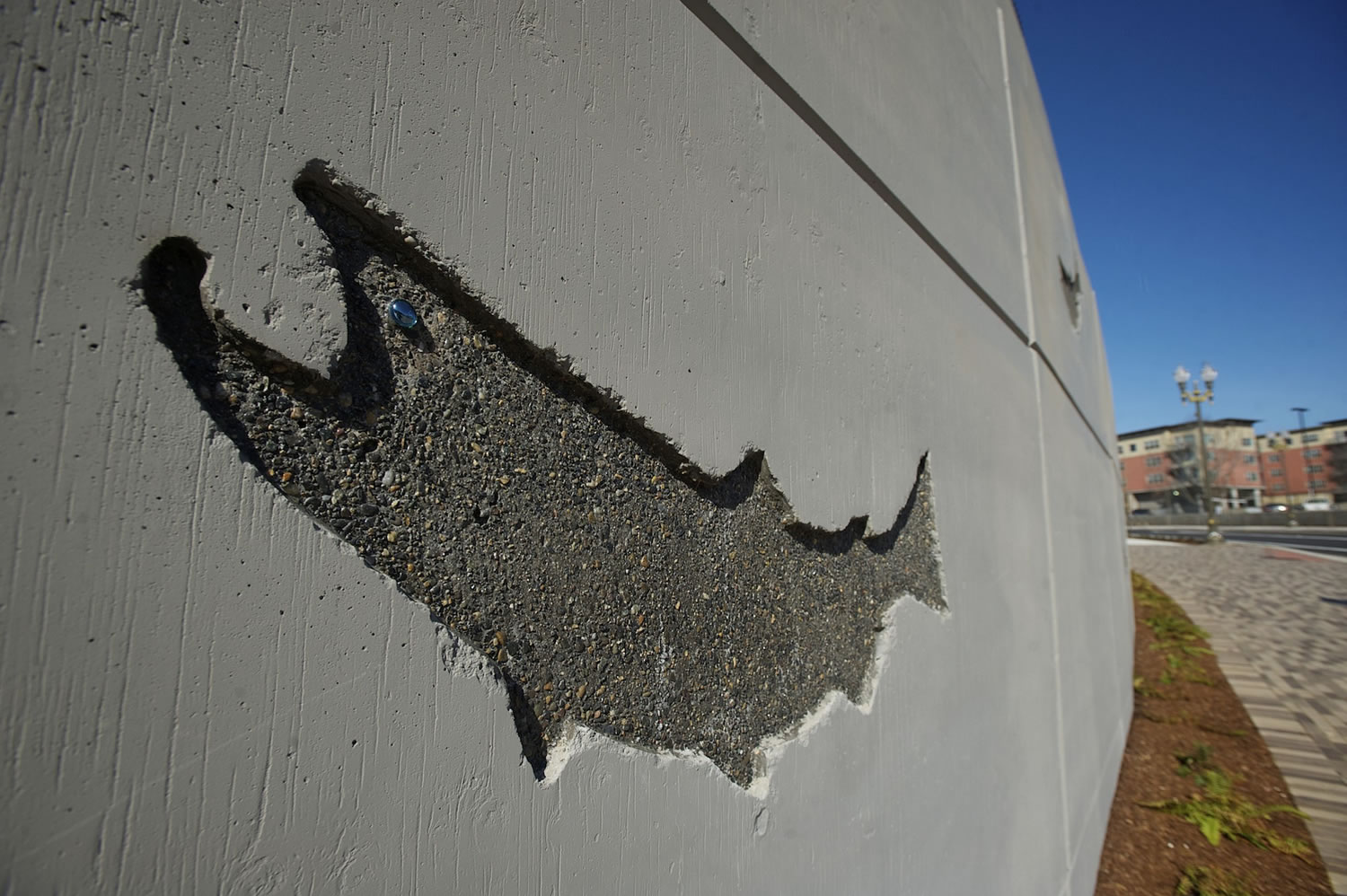 An image of a salmon is stamped into a concrete wall that was built at Grant and West Sixth streets as part of the Columbia River waterfront access project.