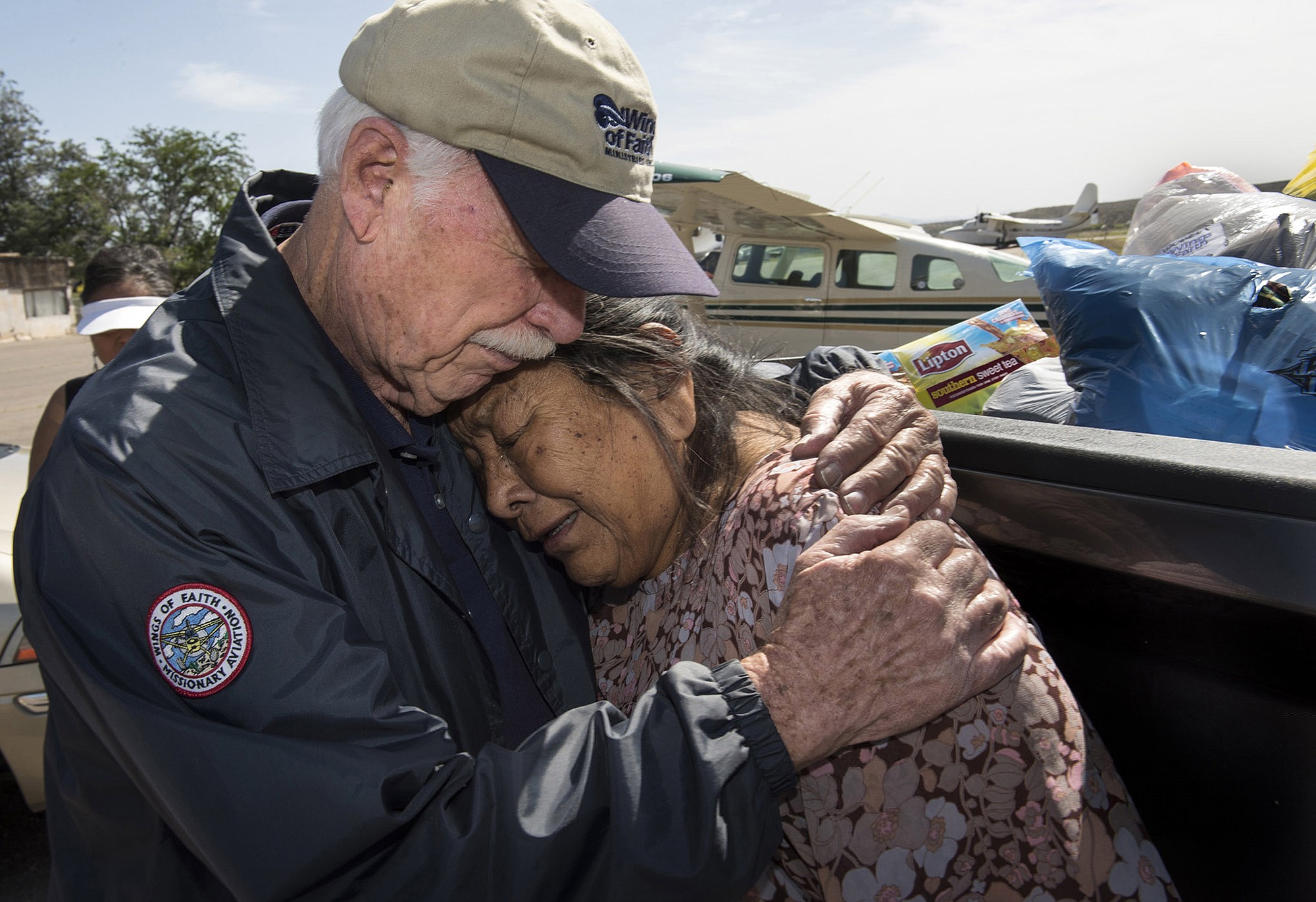 Dale Whinery, left, embraces Judy Kinney, after saying a prayer for her at San Carlos Apache Reservation in Arizona on April 9, 2015.
