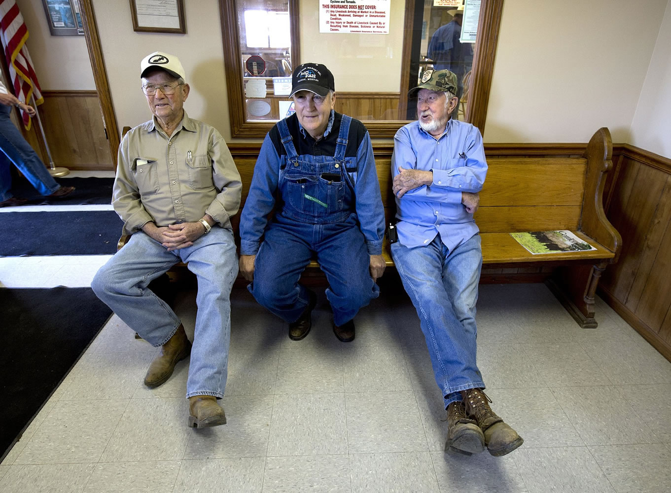 Herman Shubert, from left, Ed Shouse and Tom McGuire wait for the auction to start on April 30 at the Mo-Kan Livestock Market in Passaic, Mo.