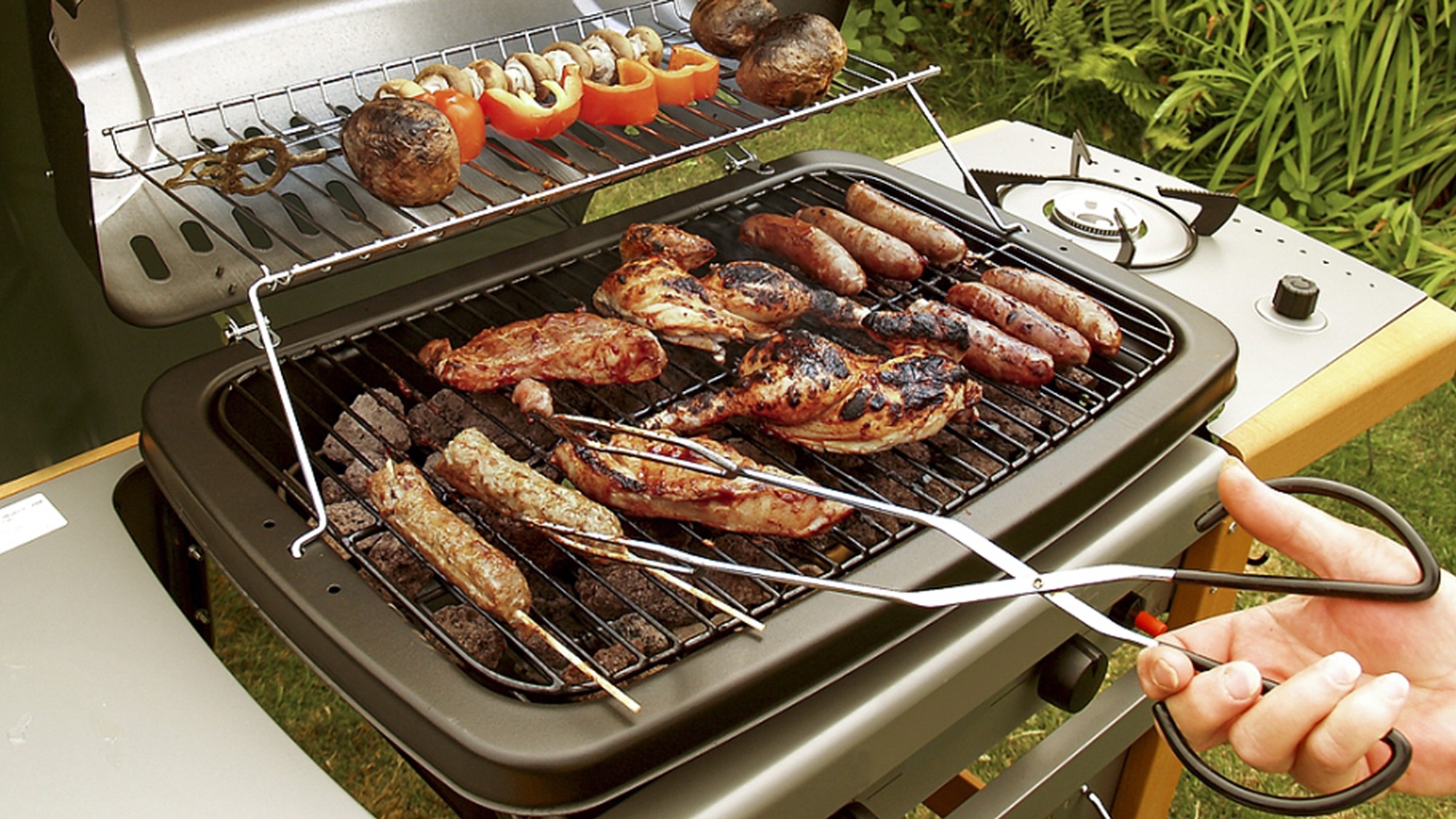 A gas grill allows variable heating options to cook several foods at once.