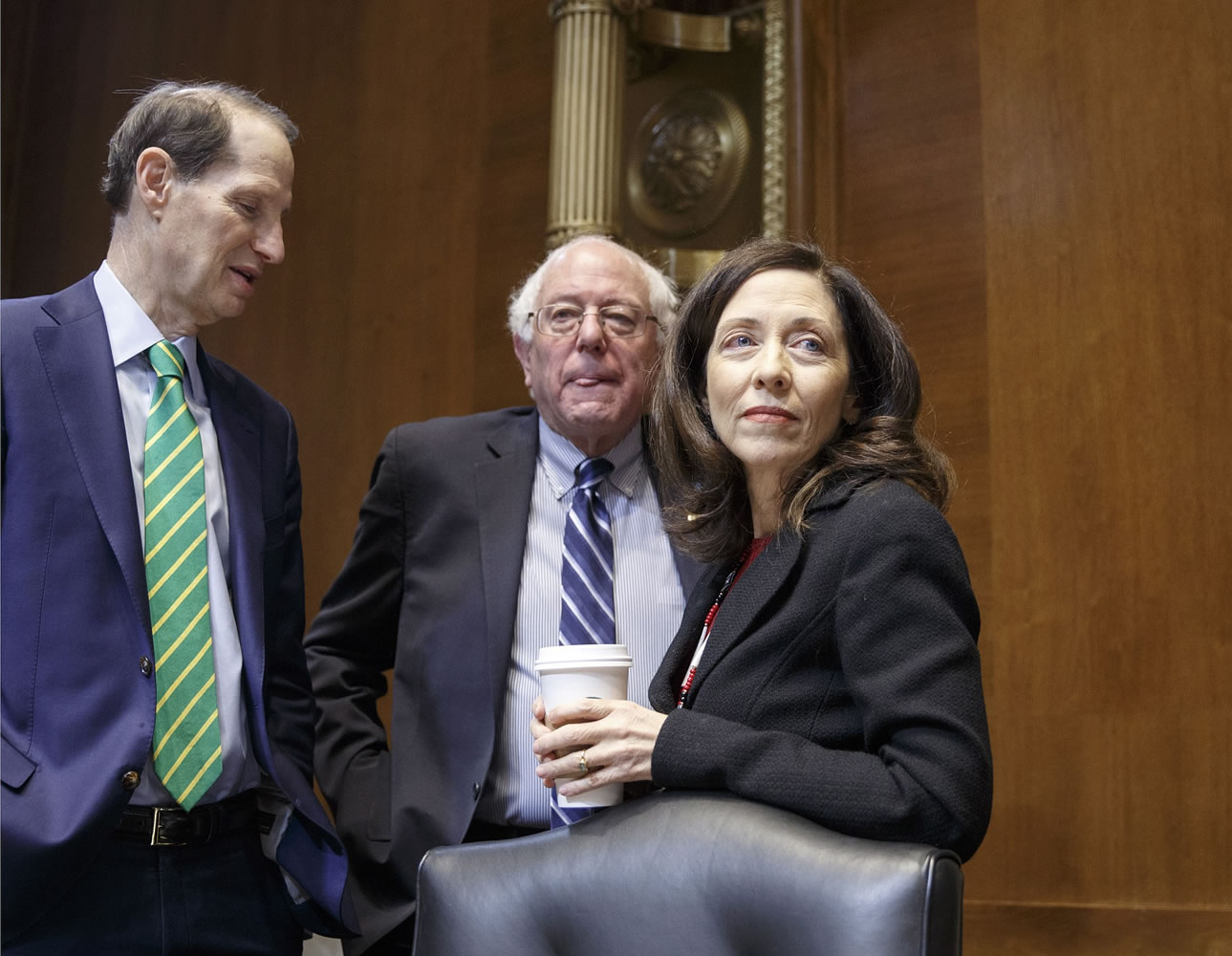 From left, Sen. Ron Wyden, D-Ore., Sen. Bernie Sanders, I-Vt., and Sen. Maria Cantwell, D-Wash., confer on Capitol Hill in Washington on Jan. 8.