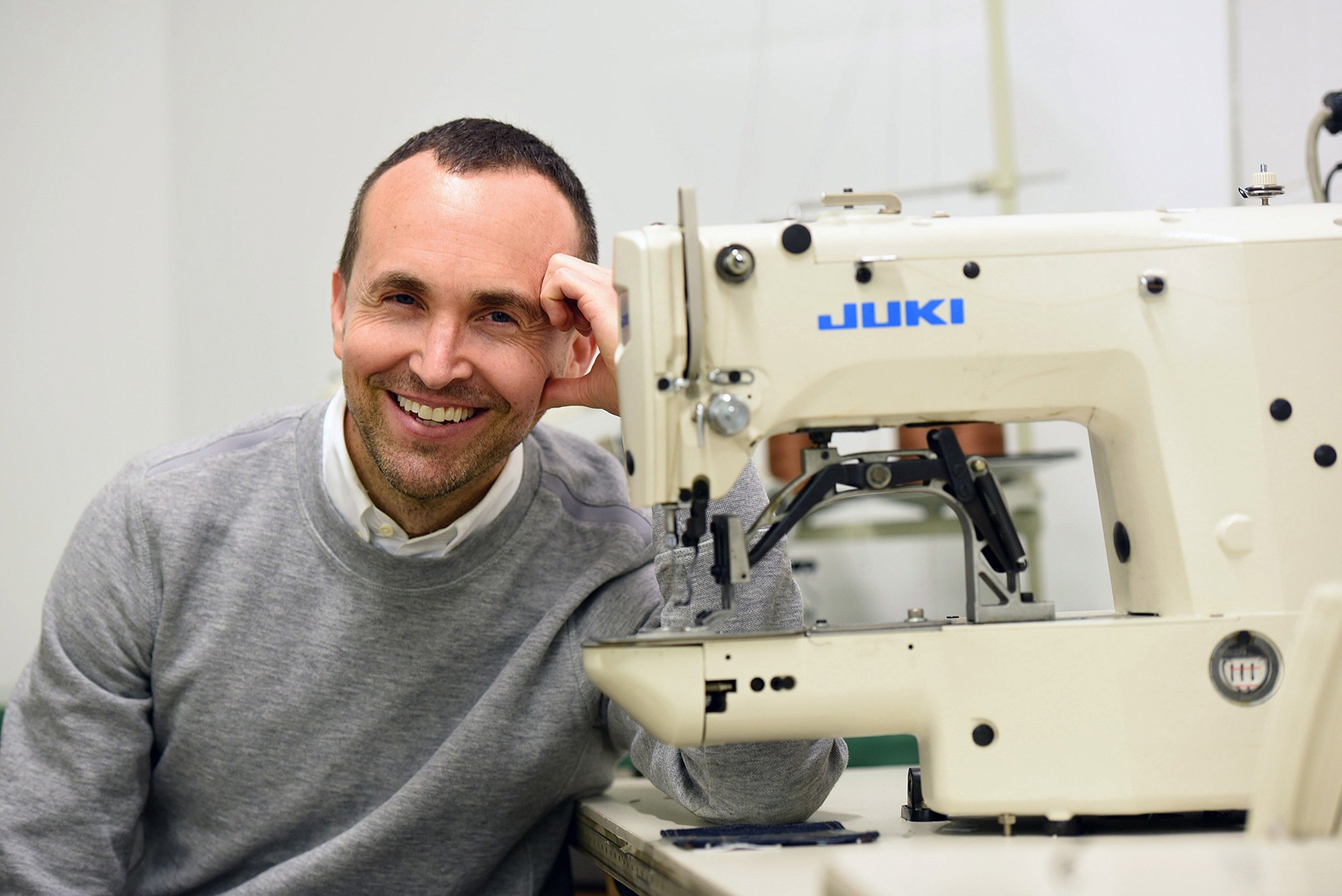 Todd Shelton poses next to one of his company's sewing machines on May 5 in East Rutherford, N.J.