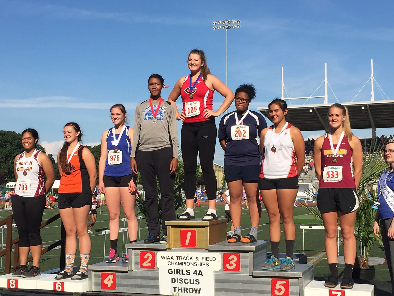 Camas' Nikki Corbett stands atop the podium as the 2015 WIAA Class 4A state girls discus champion.