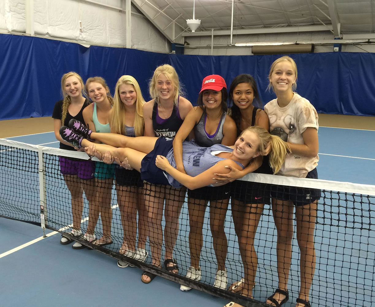 Skyview teammates hold up senior Sammi Hampton on the net on Saturday at the Columbia Basin Racquet Club in Richland after Hampton was declared the Class 4A singles champion for a fourth year in a row.