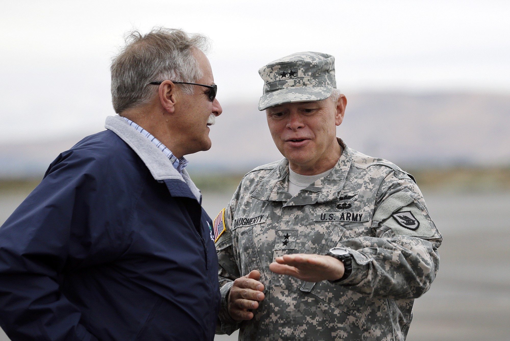 Washington Army National Guard Maj. Gen. Bret D. Daugherty, right, talks with Peter Goldmark, commissioner of the Dept.