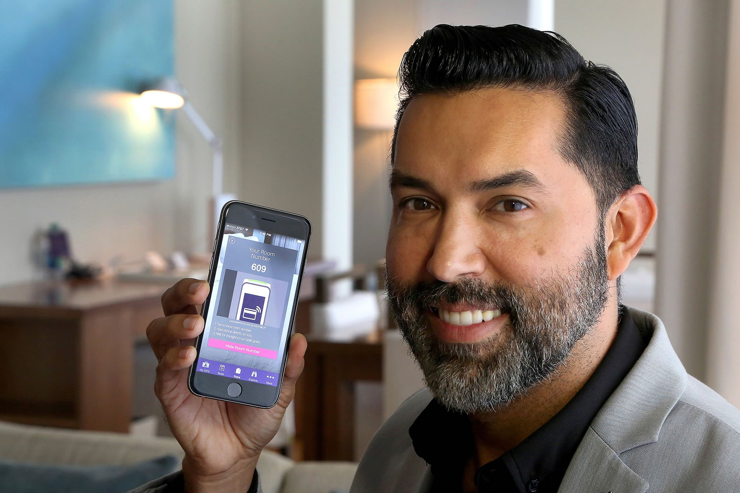 Alexis Espejo, marketing manager at the W Fort Lauderdale Hotel, shows the new keyless-entry app at the hotel.