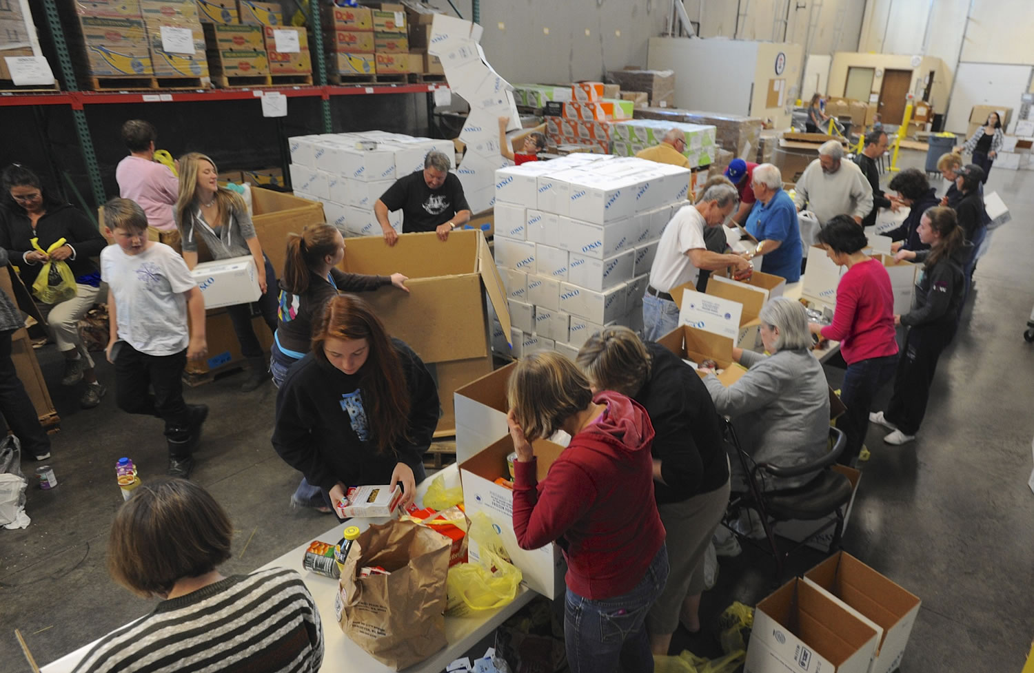 Columbian files
Volunteers box donations at the Clark County Food Bank after the 2014 National Association of Letter Carriers Food Drive. The Food Bank is looking to expand its warehouse.