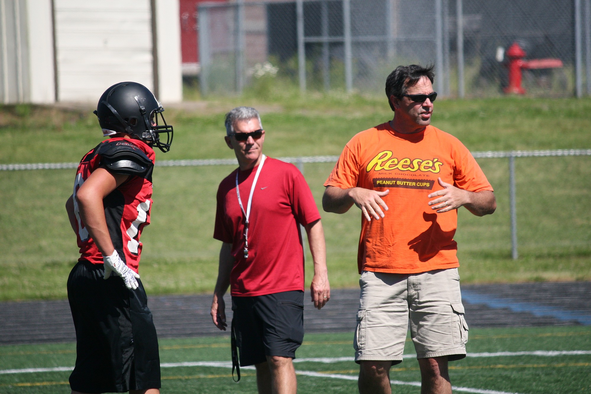 Camas High School football coaches Dan Kielty and Jon Eagle (background) get back to work Friday after WIAA District IV directors lifted their suspensions for recruiting violations Thursday.