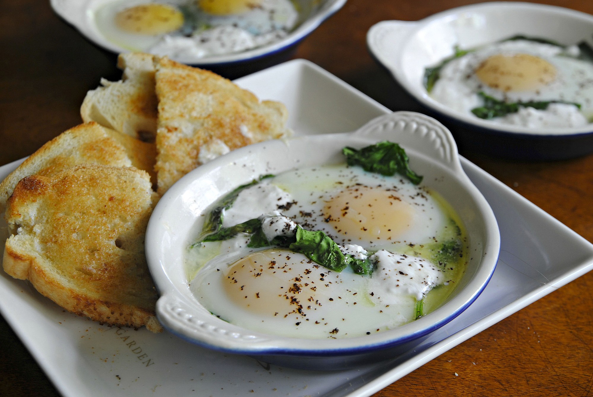 Baked eggs with Spinach, Yogurt and Sumac can be a rustic brunch or dinner.