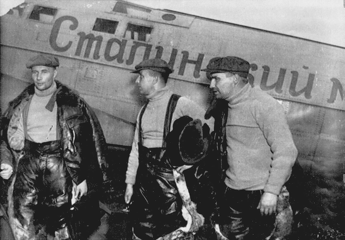 Navigator Alexander Belyakov, from left, co-pilot Georgy Baidukov and pilot Valery Chkalov stand by their plane on June 20, 1937, after completing a record-setting flight in Vancouver.