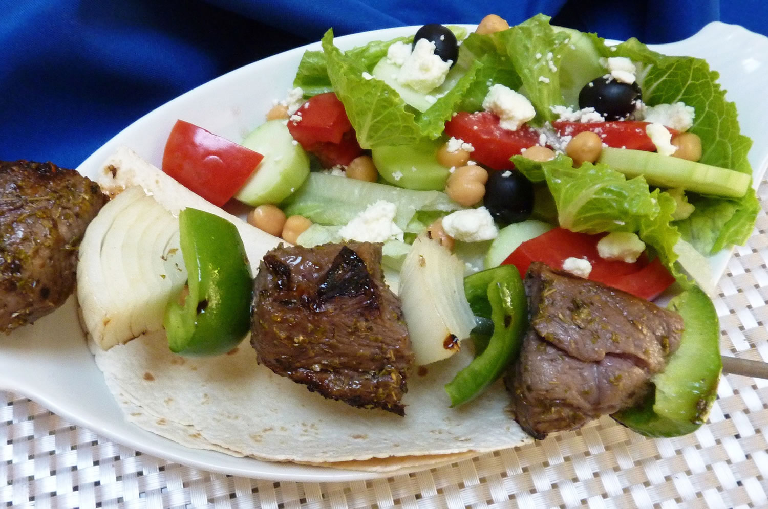Flavorful lamb kebobs paired with a hearty salad is a great, summery meal.