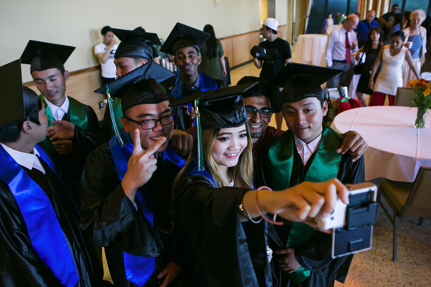 Xue Ying Yu takes a photo with fellow graduates of the Seattle World School at their commencement last week.