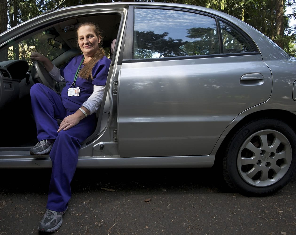 Jenny Rund, an itinerant Certified Nursing Assistant and personal caregiver, shows off her shiny new-to-her Kia Rio.