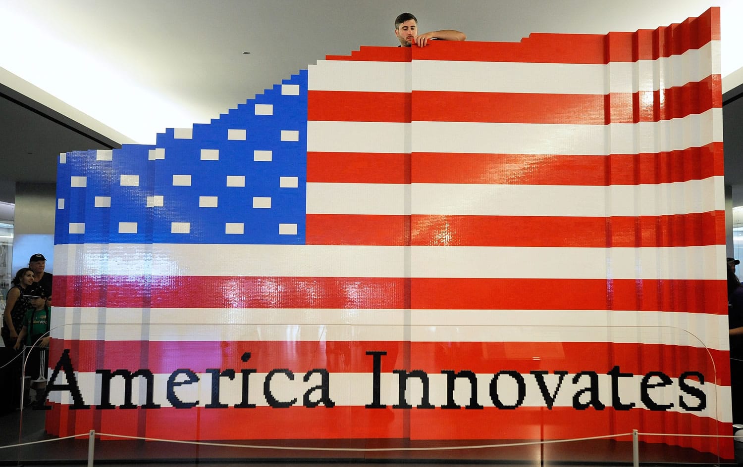 Lego master builder Chris Steininger, at top, places a brick while building the world's largest Lego American flag Wednesday at the National Museum of American History in Washington.