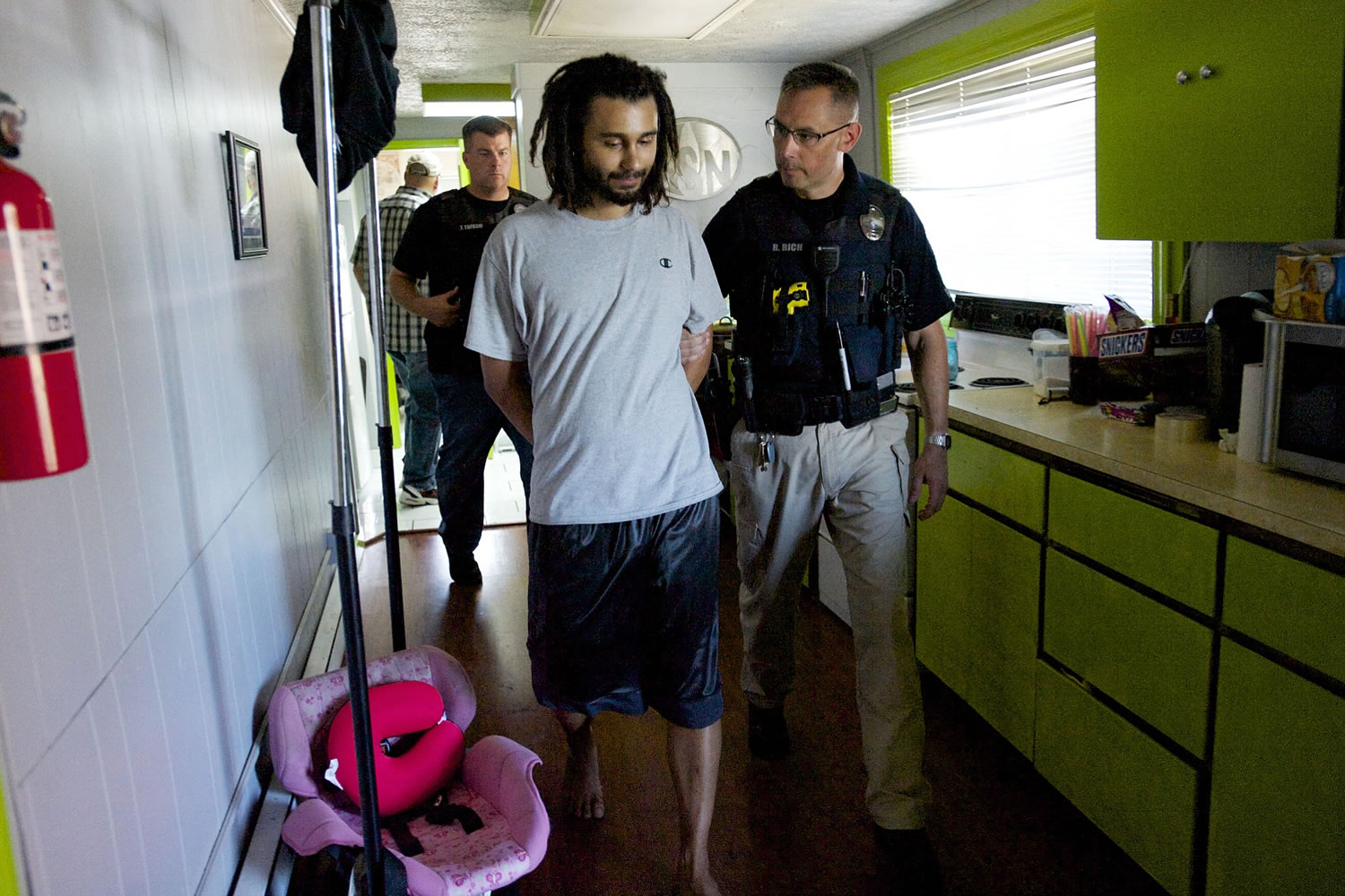 A warrant is served at the home of Adam Alexander, owner of Grow Systems Northwest, onThursday.