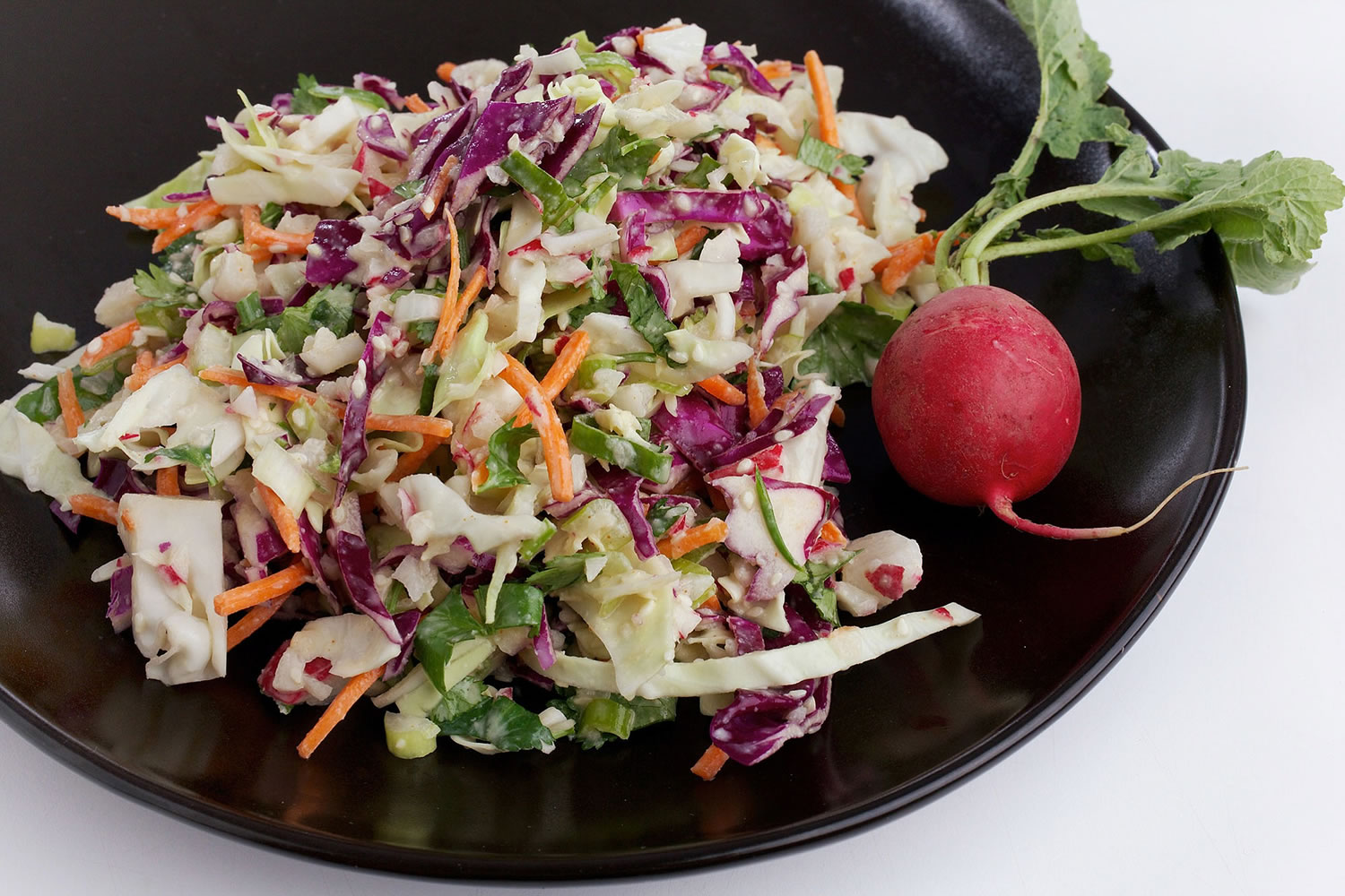 This mayonnaise-free coleslaw uses tahini, which is made from ground sesame seeds and adds protein to a salad side dish without the bad fats.