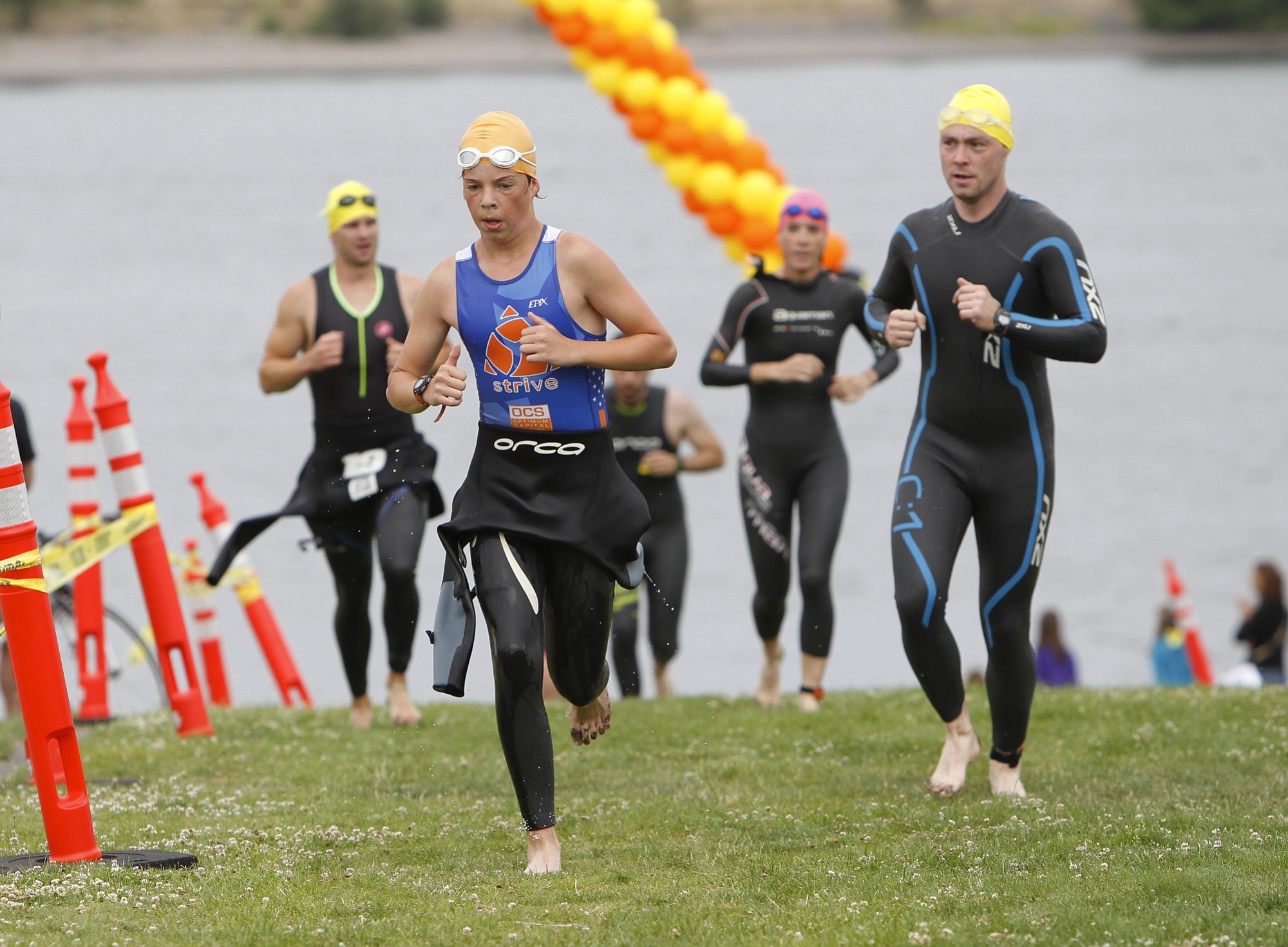 Participants leave the Columbia River following the half-mile swim portion of the Girlfriends and Dudes Triathlon on Sunday at Frenchman's Bar Park. Next was a 12.5-mile bike ride, and then a 3-mile run.