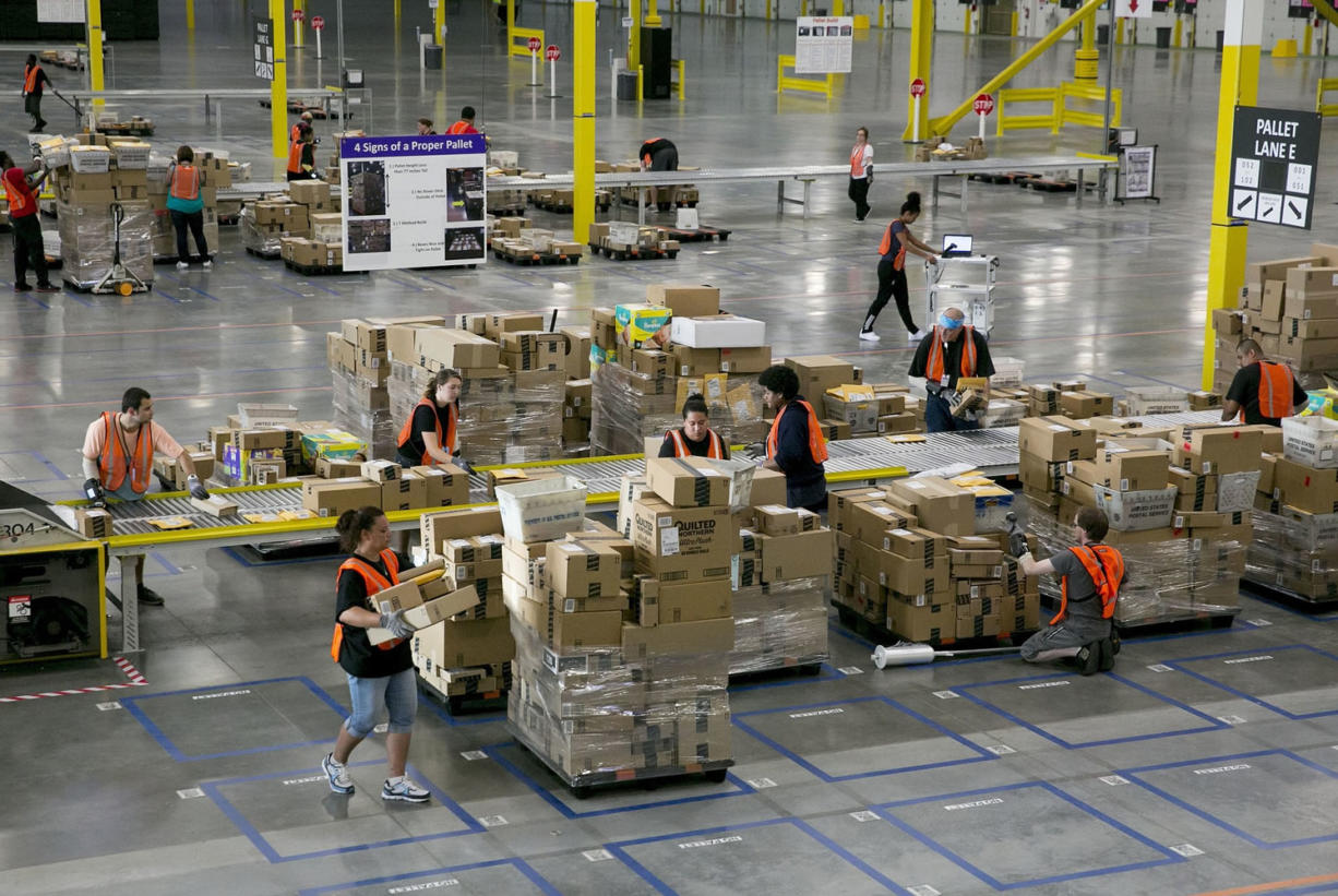 Amazon workers at the new 300,000-square-foot sortation center in Kent sort packages by ZIP codes, place them on pallets and deliver them to local post offices between 6 and 8 a.m.