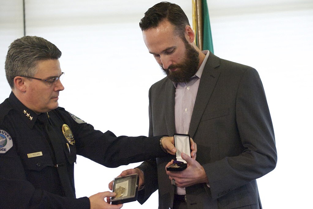 Officer Dustin Goudschaal receives the Purple Heart from Police Chief James McElvain at the Vancouver Police Department Recognition and Awards Ceremony in February.