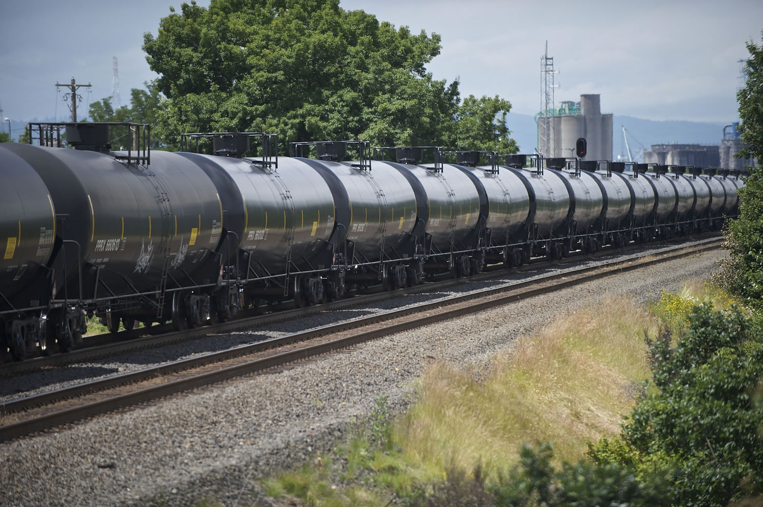 A tanker train passes near downtown Vancouver in June.