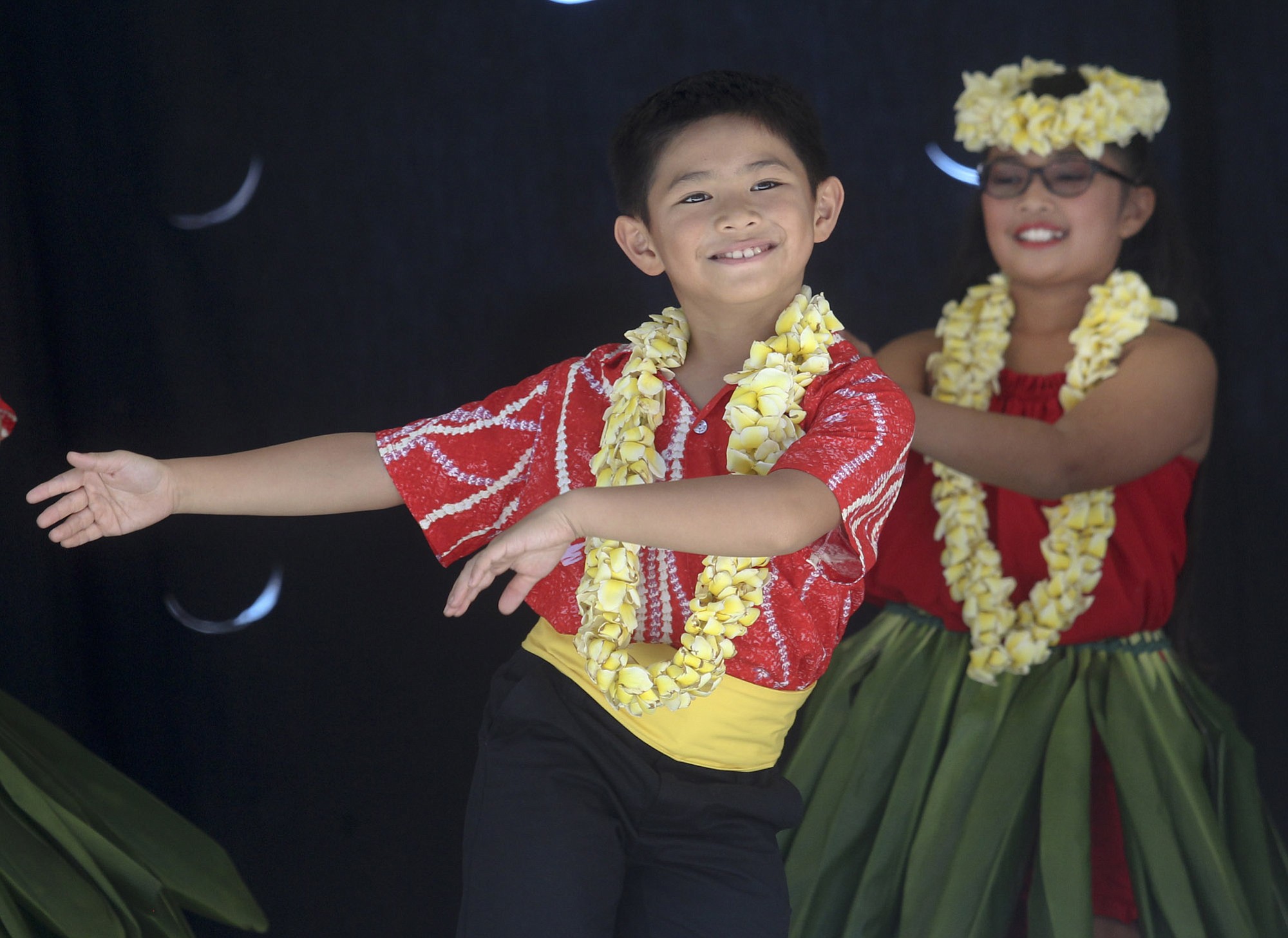 Children perform traditional Hawaiian dances at the Hou2019ike and Hawaiian Festival in downtown Vancouveru2019s Esther Short Park Saturday.