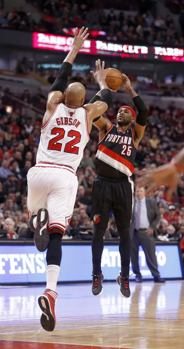 Portland Trail Blazers guard Mo Williams (25) shoots as Chicago Bulls forward Taj Gibson (22) defends during a game on March 28, 2014, in Chicago.