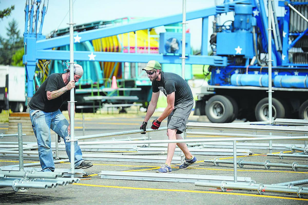 David Fuhr, left, and Thomas Freeman of Stages Northwest erect The Columbian Community Stage for this year's Clark County Fair.