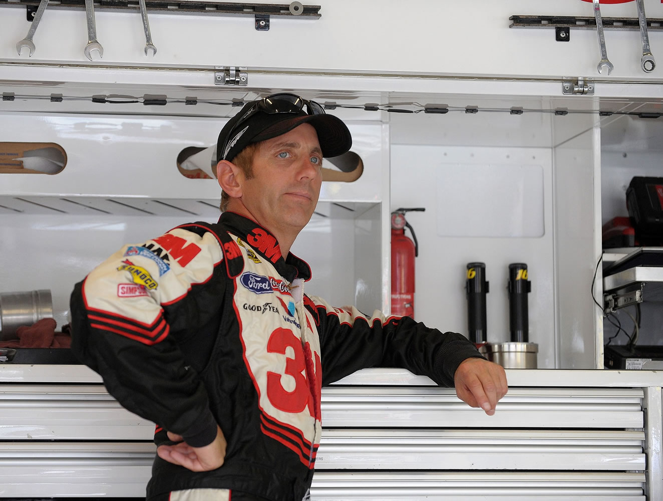 Driver Greg Biffle leans on a toolbox in the garage area before beginning practice for Sunday's NASCAR Sprint Cup Series auto race at Atlanta Motor Speedway, Saturday, Aug. 31, 2013 in Hampton, Ga.