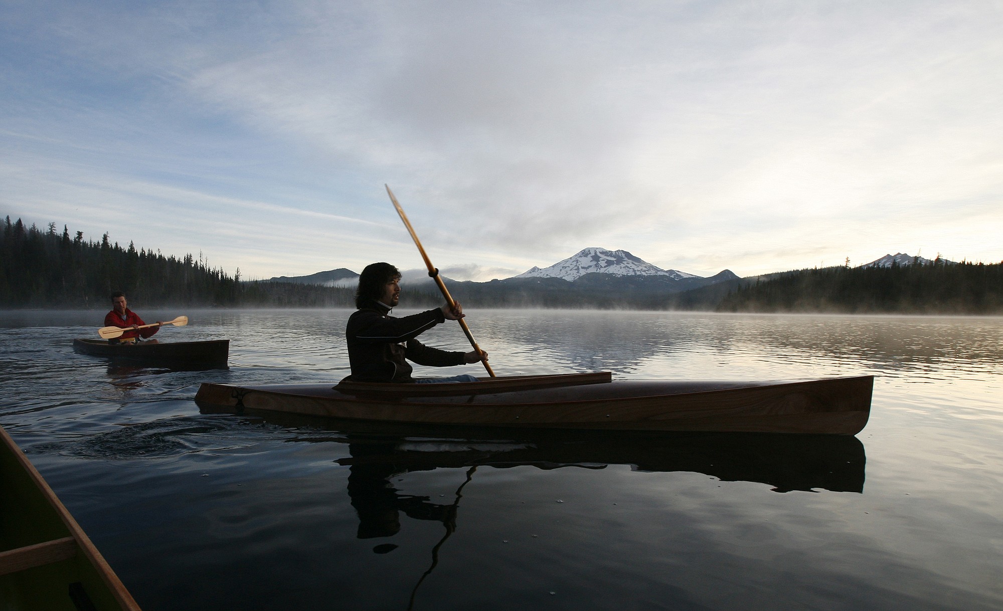 The Bulletin files
Mark Wells, 48, left, and Scott Seelye, 35, both of Bend, Ore., glide across the glassy waters of Elk Lake during an early paddle, near the Cascade Lakes Highway in central Oregon. In the distance is South Sister, the youngest and tallest in a trio of Cascade Range volcanos.