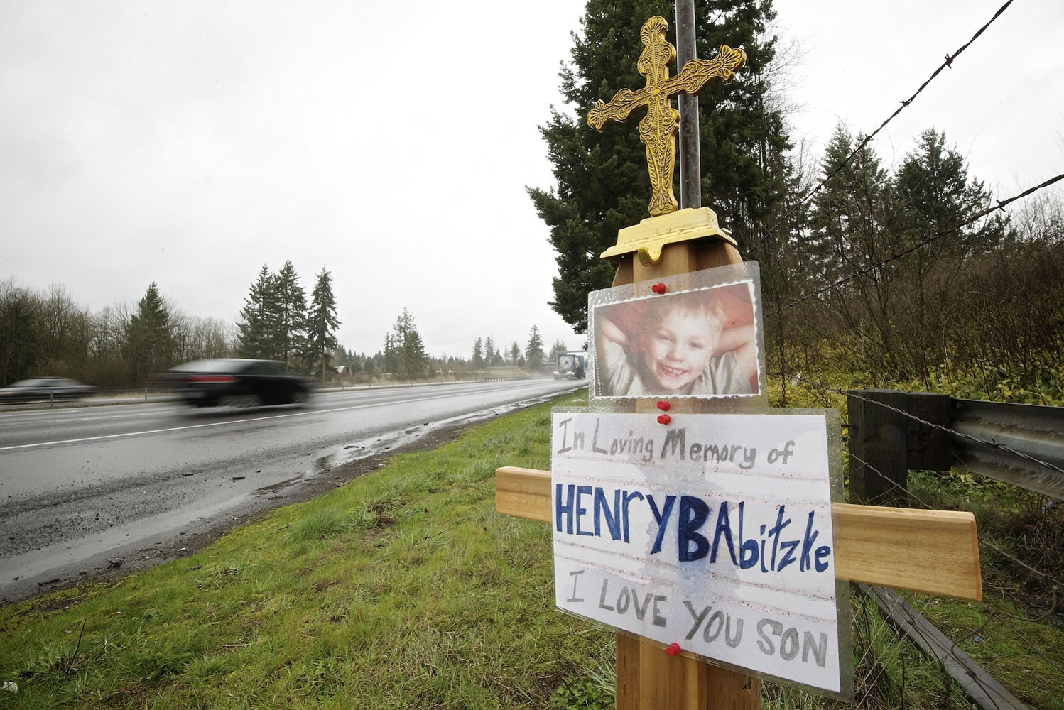 Motorists drive past a memorial for 6-year-old Henry Babitzke on March 6. He was killed in a collision on Interstate 5 on Feb.