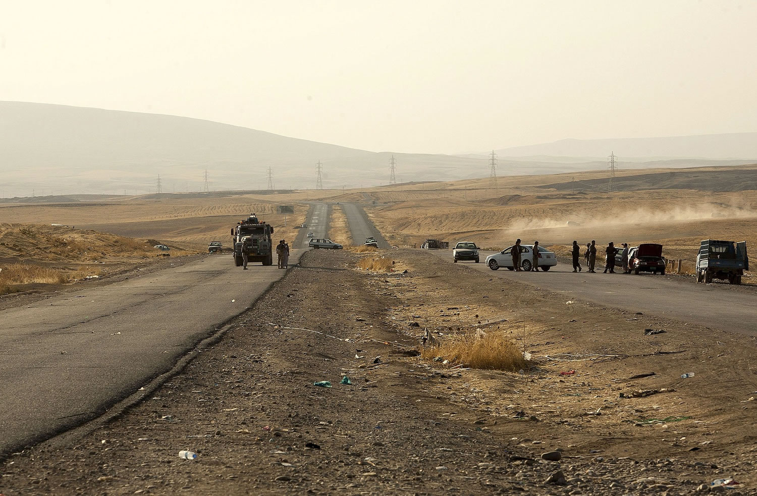 Abandoned cars that ran out of gasoline while fleeing the advance of Islamic State militants litter the highway Thursday near Kalak, Iraq, between Mosul and Irbil.