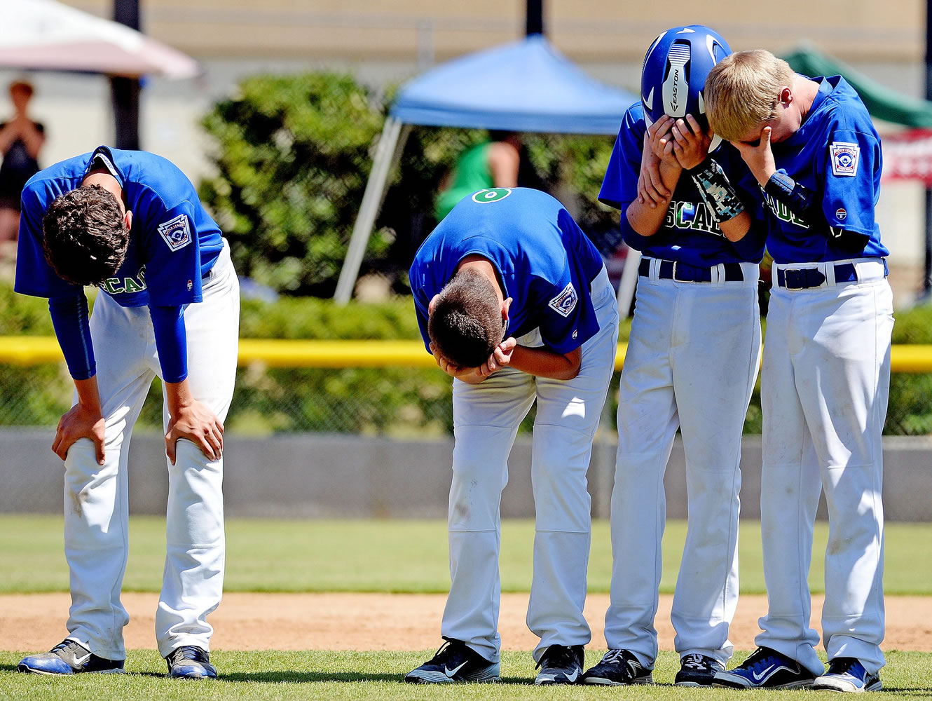 Cascade Little League players Mathew Chudek, Lucas Horowitz, Jake Bowen and Ben Jones show their disappointment after losing to Idaho 8-7 on an a aiding a player call to end the game in the bottom of the 6th inning Friday August 14, 2015 at the Little League Western Regionals in San Bernardino, Calif.