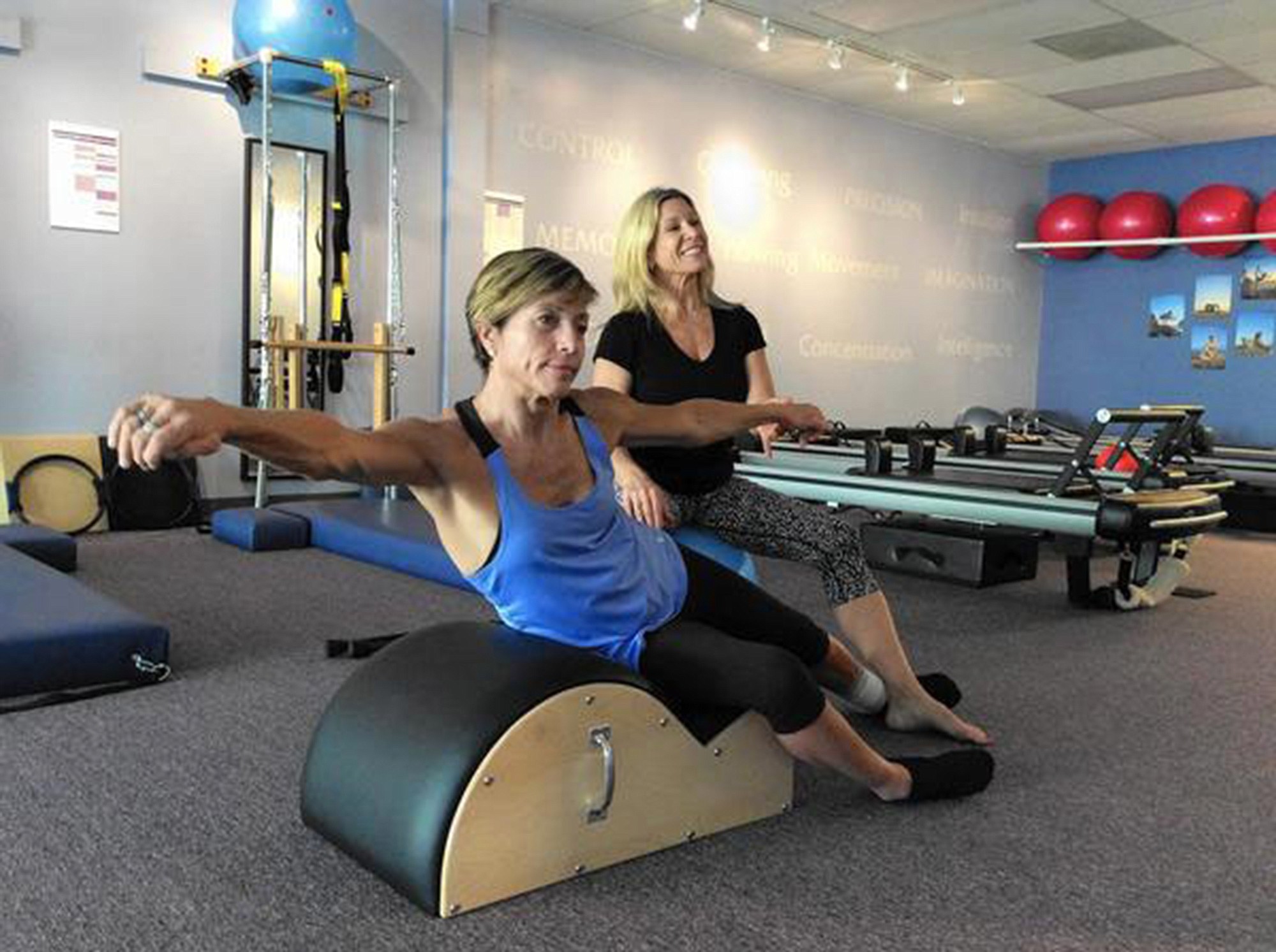 Delyn VanDyke, 52, who was hurt in a motorcycle crash in 2012, works to strengthen her body with trainer Tina Stathis, 48, at Tru Pilates and Yoga Studio in Altamonte Springs, Fla.