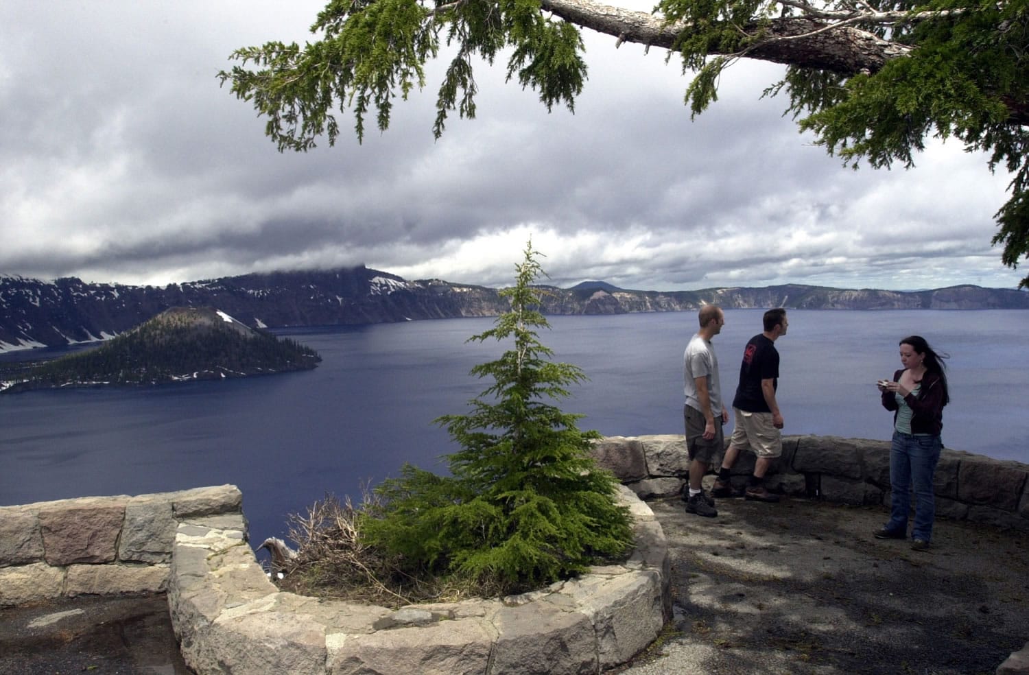 Tourists taking in the view at Crater Lake National Park, Ore.