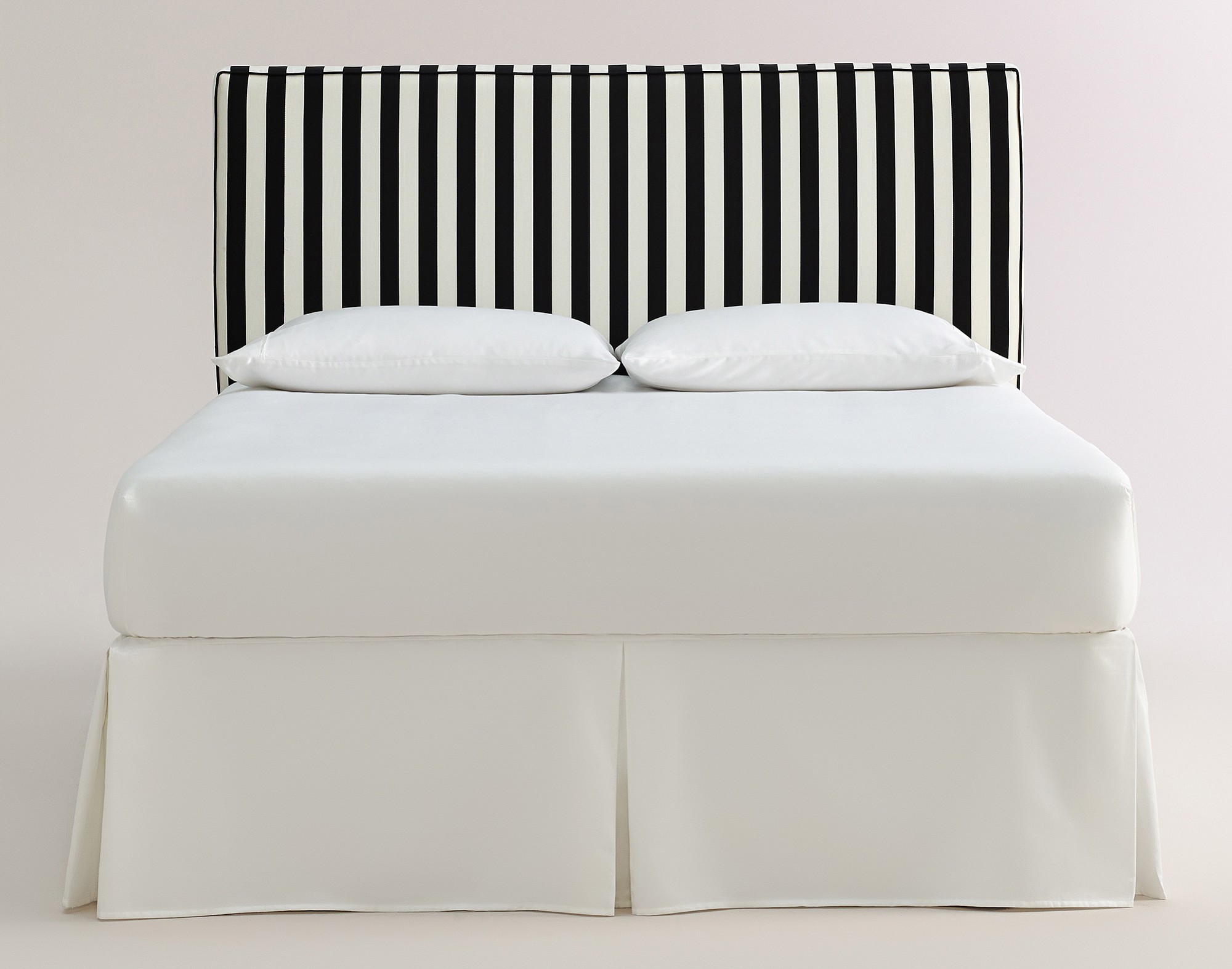 Stripes in a headboard like this black-and-white Canopy Stripe Loran Headboard from World Market can create a focal point in a room.