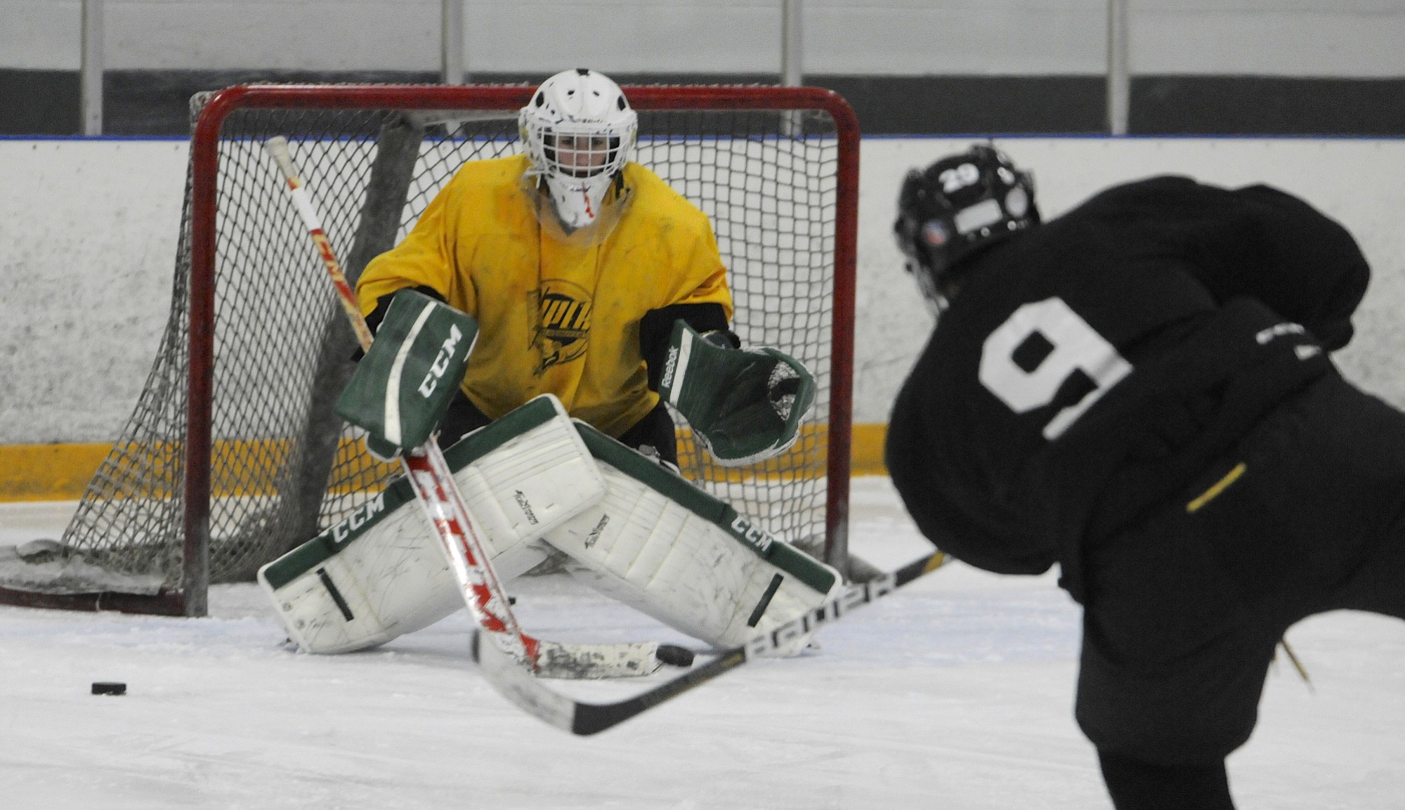 Fort Vancouver Vipers player Eric Bampenchow, right, takes a shot on goalie Brenden Leise during a practice at the Mountain View Ice Arena in Vancouver.