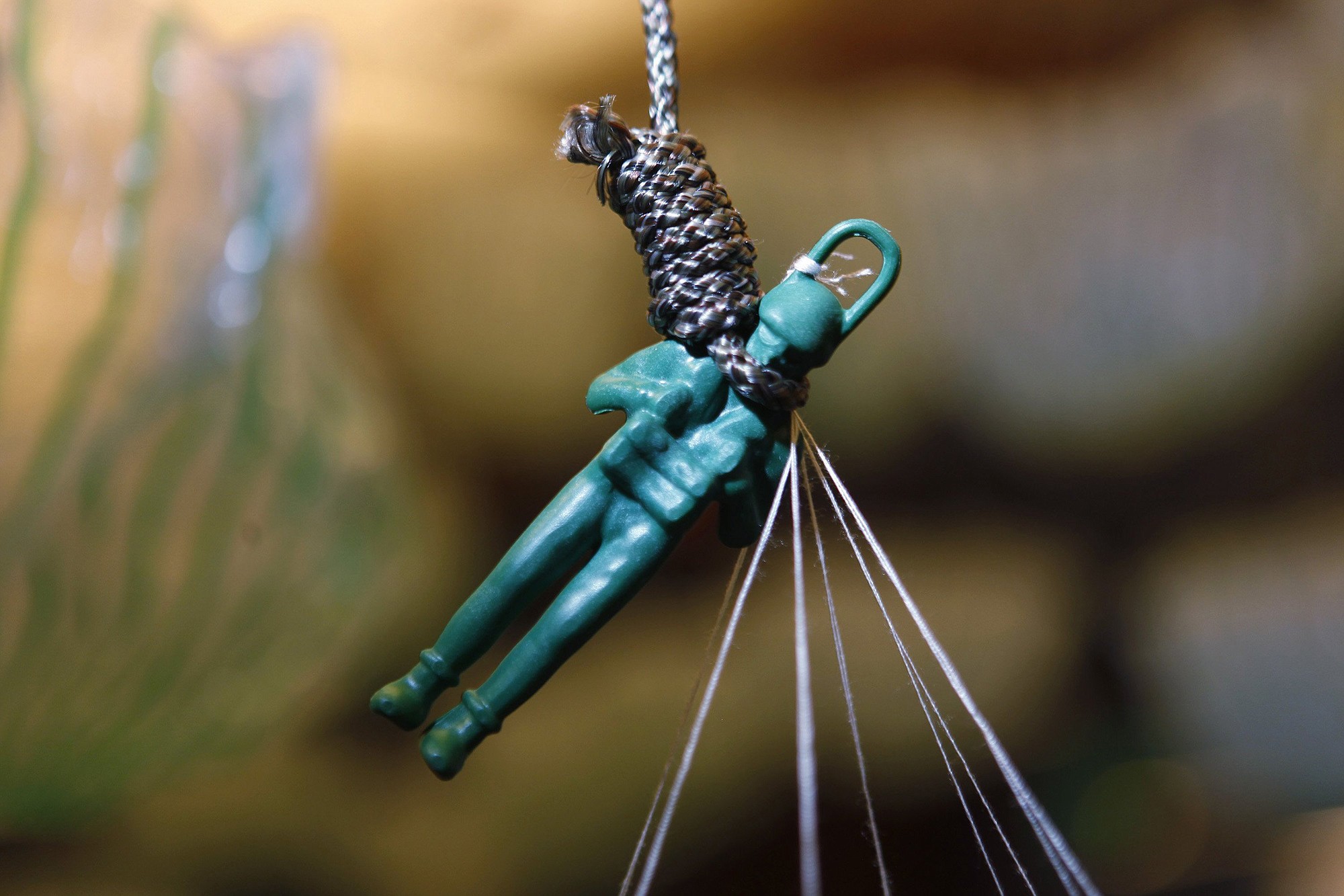 A hanging toy soldier represents veterans suicides in an art installation by Mark Pinto at San Jose Martin Luther King Library in San Jose, Calif.