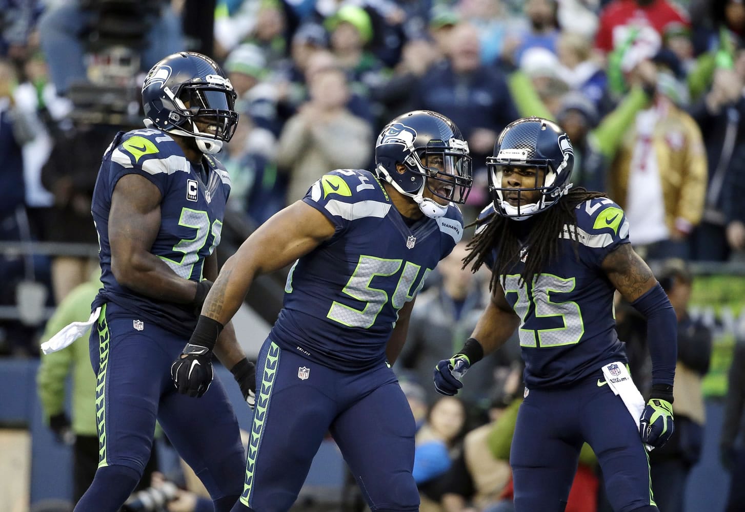 Seattle Seahawks middle linebacker Bobby Wagner (54) celebrates his tackle of San Francisco 49ers running back Alfonso Smith (not shown) along with Richard Sherman, right, and Kam Chancellor, left, in the second half Sunday, Dec.