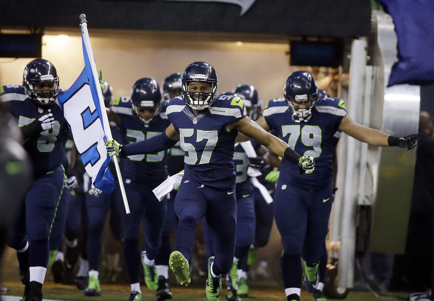Seattle Seahawks linebacker Mike Morgan (57) leads teammates out of the tunnel before an NFL divisional playoff football game against the Carolina Panthers in Seattle, Saturday, Jan.