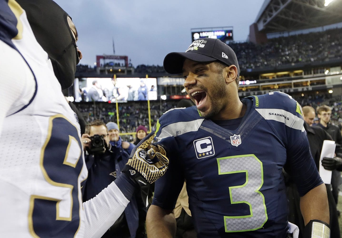 Seattle Seahawks quarterback Russell Wilson (3) celebrates as he greets St. Louis Rams players after the Seahawks won 20-6 Sunday, Dec.