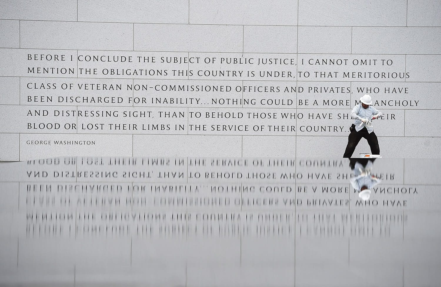 MATT McCLAIN/Associated Press
Lionel Reyes works at the American Veterans Disabled for Life Memorial on Monday in Washington. A ceremony to dedicate the new memorial is scheduled for Sunday.