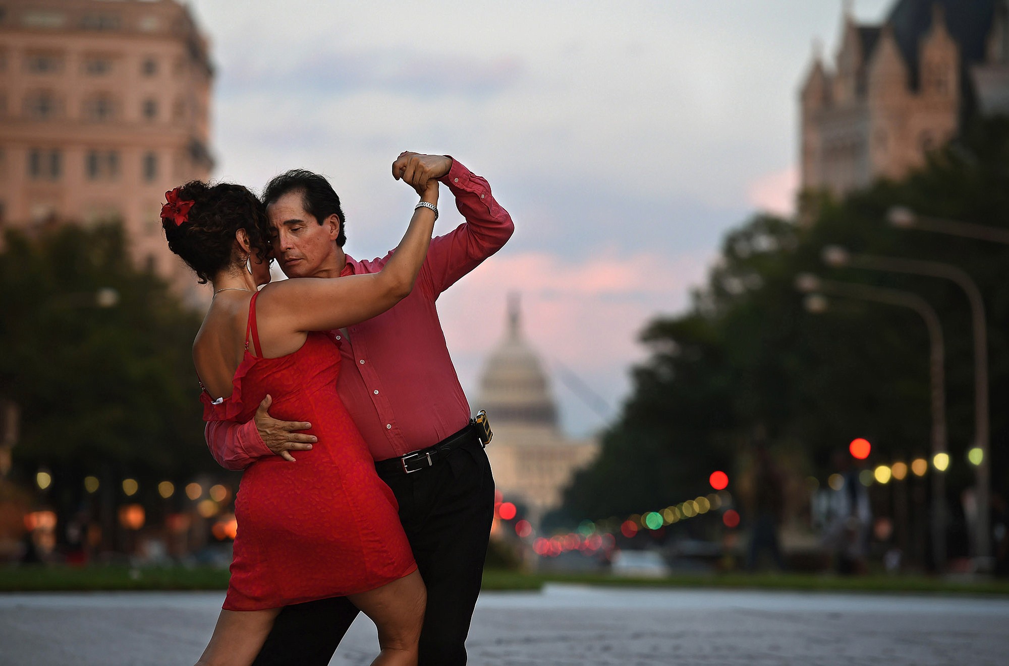 Mitra Fard dances with Carlos Gutierrez in a weekly tango dance at Freedom Plaza in Washington, D.C., late this summer; scientists have confirmed that the precise movements of the tango have therapeutic effects.