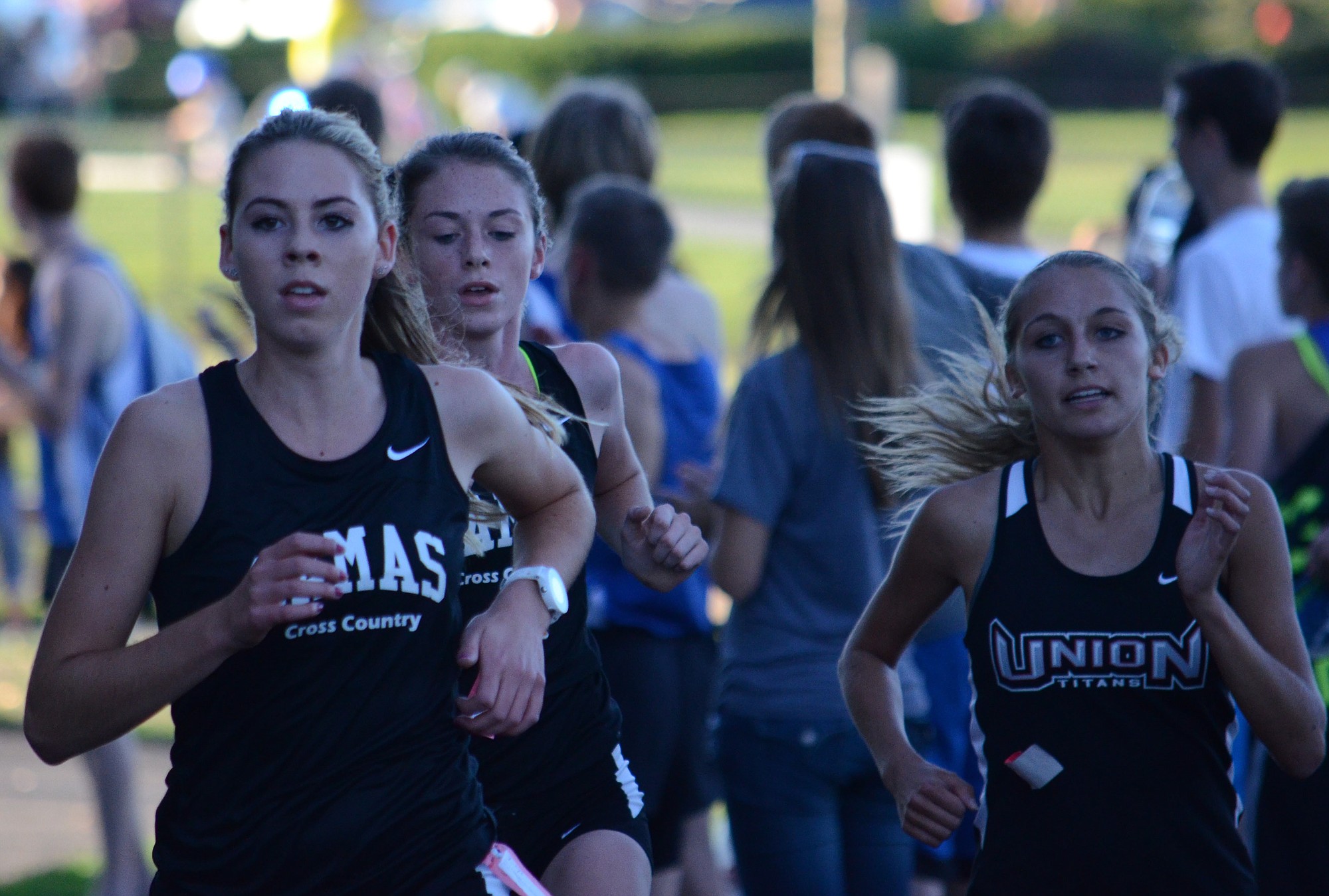 Alissa Pudlitzke, left, of Camas leads a high school cross country race Oct. 7 at Pacific Park in Vancouver.