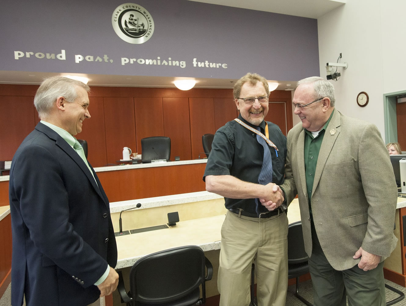 Clark County Councilor Tom Mielke, right, congratulates Gary Bickett, Clark County Public Health's food safety and solid waste program manager, on his upcoming retirement after nearly 32 years with the county.