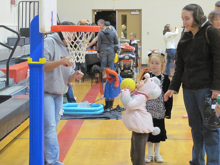 A youngster shoots hoops during the annual Family Halloween Night at Liberty Middle School.