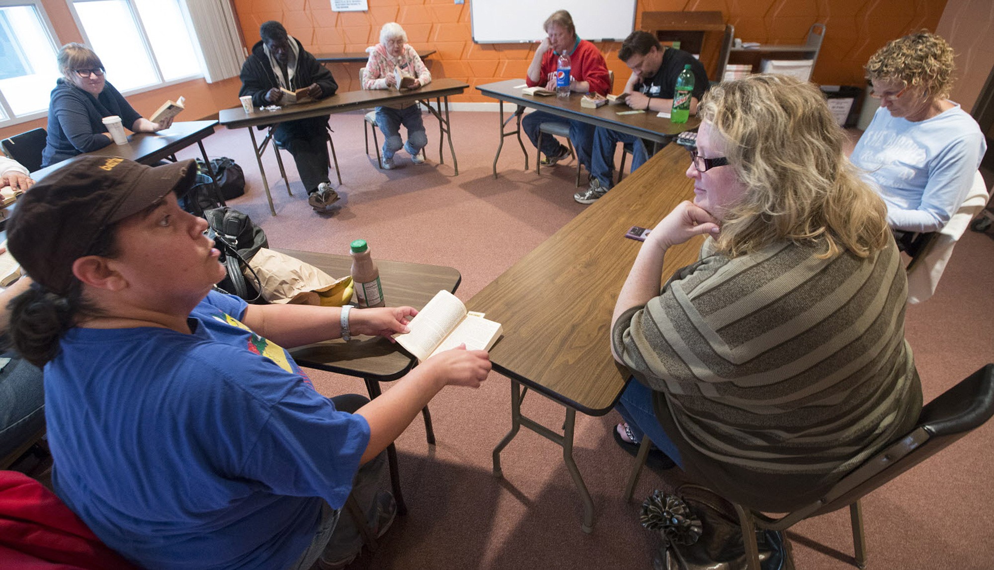Mark Hoffman/Milwaukee Journal Sentinel
Linda Hansen, left, talks with discussion leader Dannelle Gay, right, during a book club gathering for homeless people at Bethel Lutheran Church in Madison, Wis.