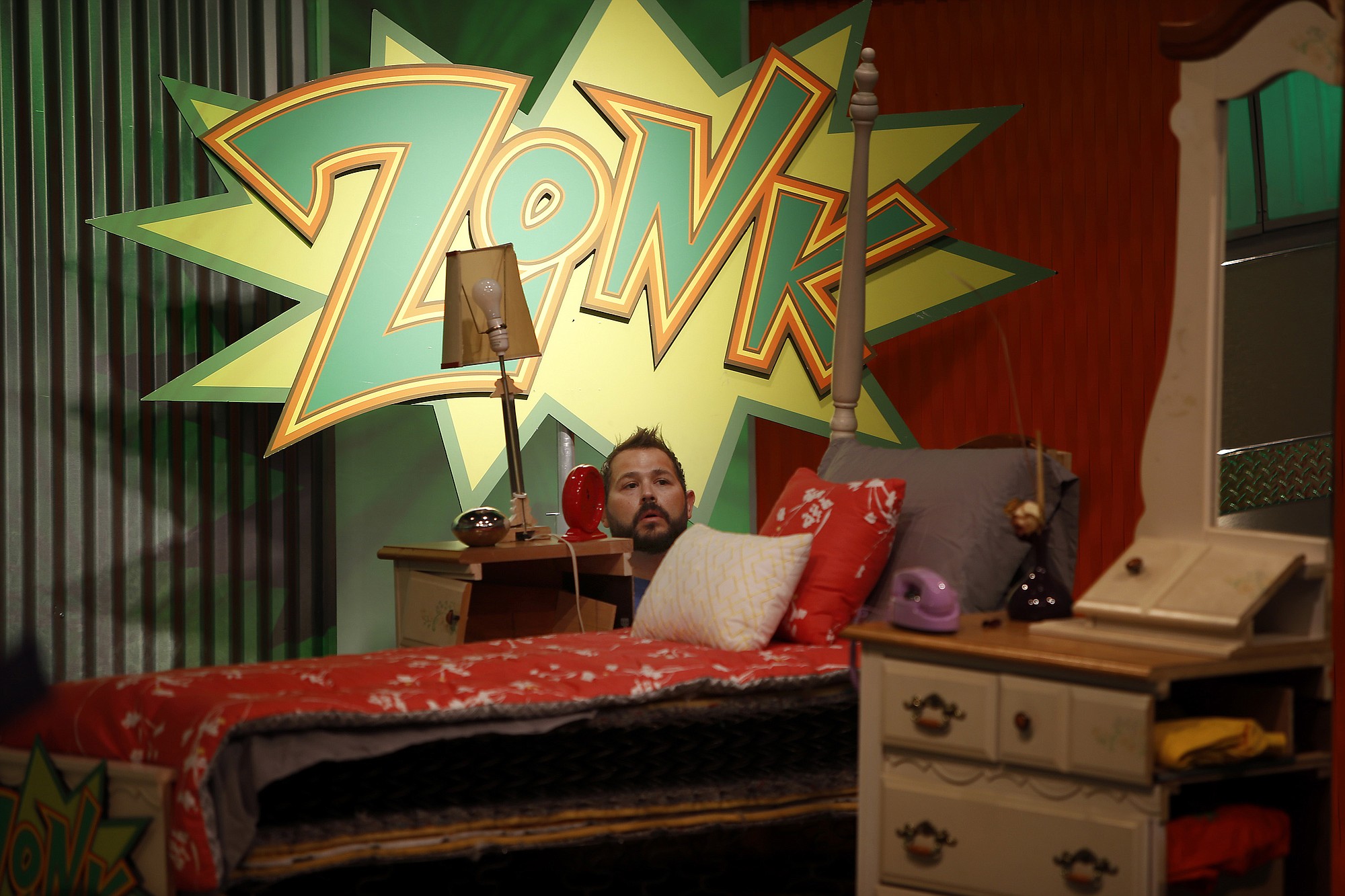 &quot;Zonk&quot; producer-lead man Jersey Feimster pokes his head up from behind a Zonk prize: A half a bedroom set, during rehearsal for &quot;Let's Make a Deal.&quot; Zonks are undesirable items.