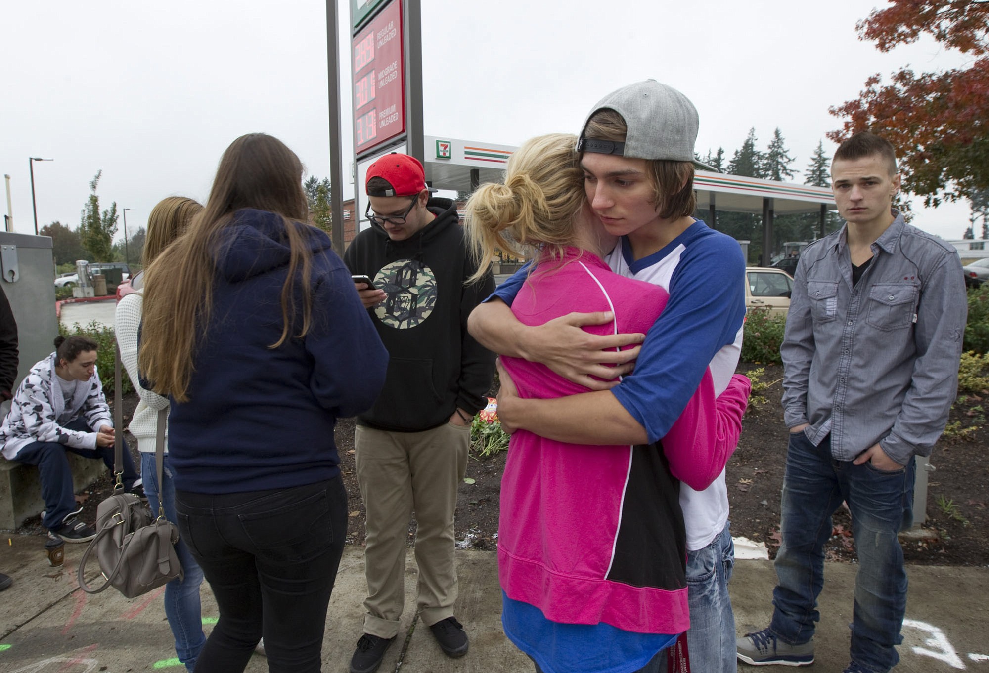 Mountain View High School students Daisy Garcia and Mark Hall hug as the two mourn their friends, who died Friday night in a car crash at the corner of Northeast 136th Avenue and Fourth Street.