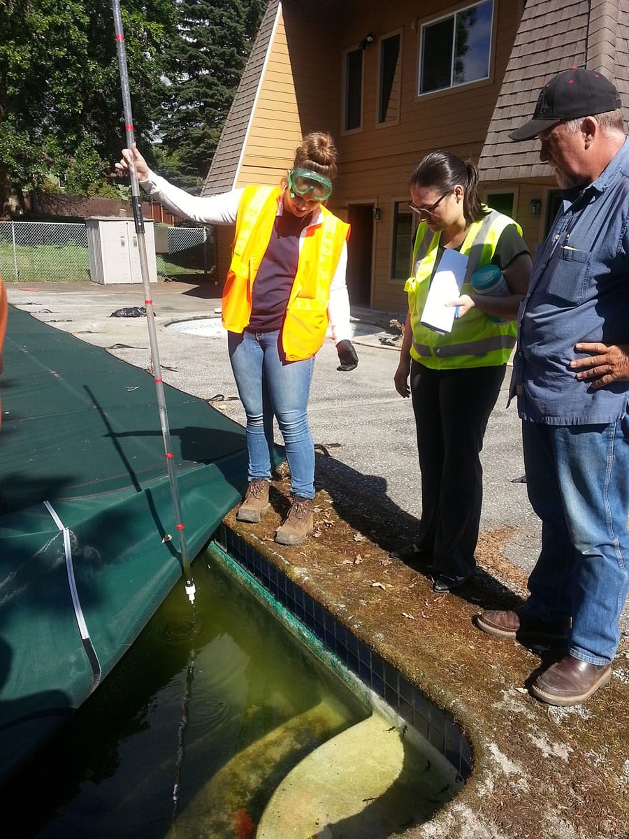 Clark Regional Wastewater District staff take water samples from the pool maintained by the Mt. Vista Homeowners Association.