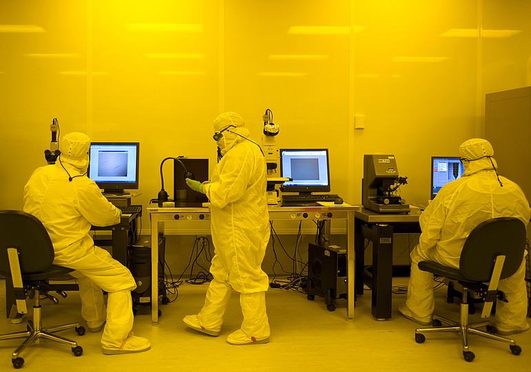 NLight employees work under colored lights inside the clean room in 2008.